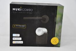 A boxed as new Nuki Combo smart lock 2.0 plus bridge.