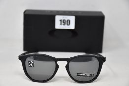 A boxed as new pair of Oakley Pitchman R glasses Satin Black frame with Prizm Black Polarized lenses