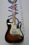 A Fender Player Series Stratocaster HSS in a burst finish.