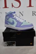 A pair of as new Nike Air Jordan 1 Mid (UK 7).