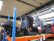 Three pushchairs/buggies and two car seats/booster seats.