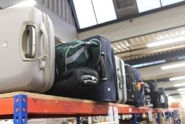 A quantity of empty pre-owned suitcases and holdalls.