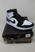 A pair of as new Nike Air Jordan 1 Mid (UK 8).
