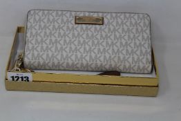 An as new Michael Kors wristlet bag.