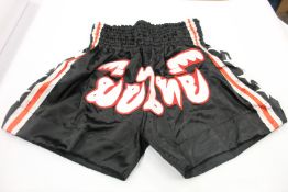 As new Thai Boxing shorts in red, white and black (Approximately 15 pairs, various sizes).