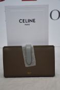 An as new Celine large strap wallet in pebble/mineral (RRP £530).