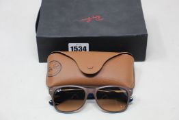 A pair of as new Ray Ban sunglasses.