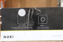 A boxed as new Nuki Combo smart lock 2.0 plus bridge.