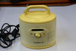 A Medela Symphony double breast pump (Unit and case only).