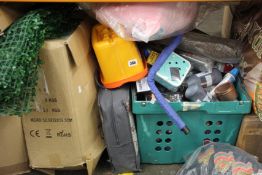 A shelf containing miscellaneous items to include household items, souvenirs and toys.