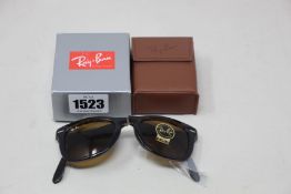 A pair of as new Ray Ban folding sunglasses.