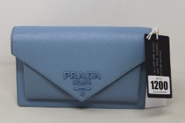 An as new Prada Saffiano leather mini envelope bag in powder blue (RRP £ 1,650).