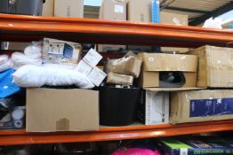 A shelf containing miscellaneous items to include household items, souvenirs and toys.