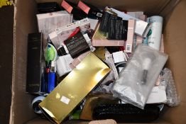 A box of assorted luxury beauty items and cosmetics.
