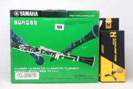 A boxed as new Yamaha YCL-255S Clarinet and an as new Hercules Flute/Clarinet Stand.