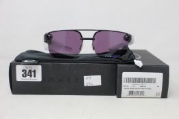 Two boxed as new Oakley Chrystl matte black frame with prizm indigo lenses (888392427021).