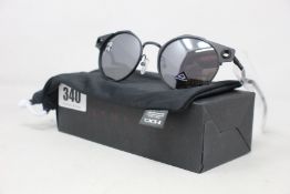 A boxed as new pair of Oakley Deadbolt sunglasses Satin Black frame with Prizm Black Polarized