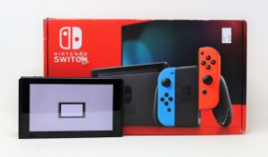 A boxed pre-owned Nintendo Switch console in black (main unit and power supply only) (damage to