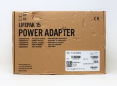 A boxed as new Physio-Control LIFEPAK 15 DC Power Adapter (P/N: 11140-000074) (Box opened, damaged