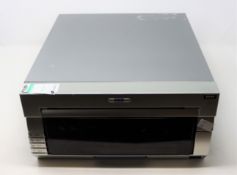 COLLECTION ONLY: A pre-owned DNP DS40 photo printer (Some cosmetic damage).
