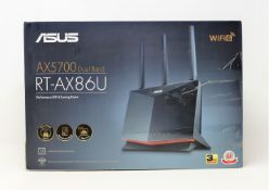 A boxed as new ASUS RT-AX86U 5700 Dual Band Wi-Fi 6 Gaming Router (Box opened, some damage to box.
