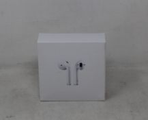 Fifty one pairs of unbranded wireless headphones in charging cases.