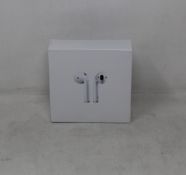 Fifty pairs of unbranded wireless headphones in charging cases.