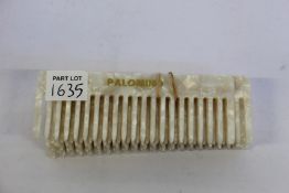 Eight Palomino wide tooth combs in pearl.