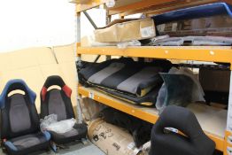 A pallet of miscellaneous automotive parts to include car seats and bumpers.