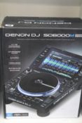 A Denon DJ SC6000M Prime Professional DJ media player with a 10.1