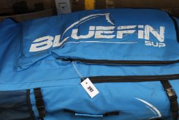 A pre-owned Bluefin SUP paddle board with accessories.