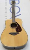 A pre-owned Yamaha FG730s acoustic guitar.