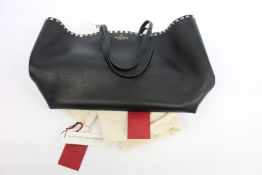 An as new Valentino black leather tote bag.