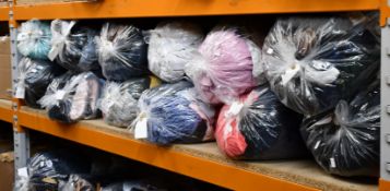 Twelve bags of pre-owned clothing and related items.