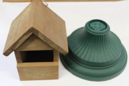 Two crates of wooden garden items to include bird feeders, planters and other items.