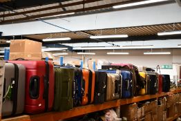 A quantity of empty suitcases/holdalls (Approximately 25 items).