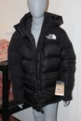 A women's as new The Himalayan down parka in black (M - RRP £320).