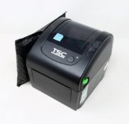 A pre-owned TSC DA200 Desktop Direct Thermal Barcode Printer (Power supply included) (Tested,