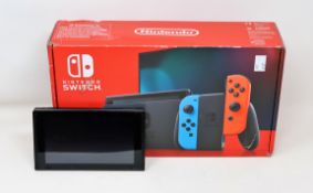 A boxed pre-owned Nintendo Switch console in black (main unit and power supply only) (damage to