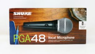 A boxed as new Shure PGA48 Dynamic Vocal Microphone (P/N: PGA48-XLR-E).