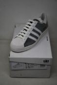 A pair of as new Prada Adidas Superstar sneakers (UK 9.5).