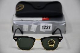 A pair of as new Ray Ban sunglasses.