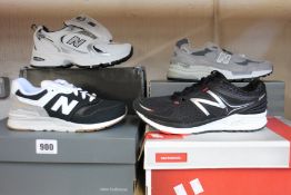 Four pairs of assorted as new New Balance trainers.