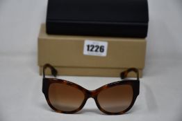 A pair of as new Burberry sunglasses.