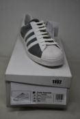 A pair of as new Prada Adidas Superstar sneakers (UK 11.5).