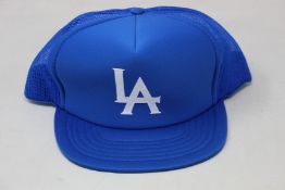 A quantity of as new blue LA baseball caps.
