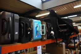 A quantity of empty suitcases/holdalls (Approximately 20 items).