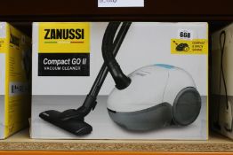A new Zanussi Compact Go ll White, 750W, 1.5L, 5M automatic cord rewind vacuum cleaner.