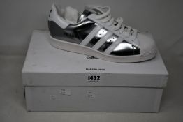 A pair of as new Prada Adidas Superstar sneakers (UK 8).