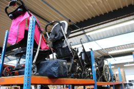 Four pushchairs/buggies, a car seat and two wheelchairs.